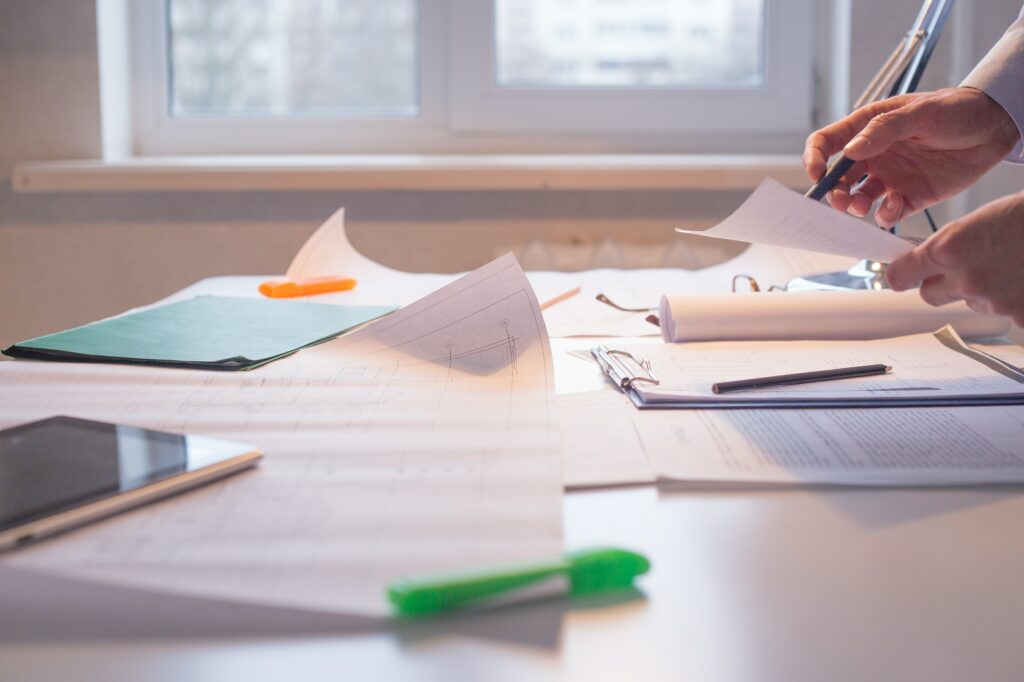 Architect alone at his working place. Paperwork