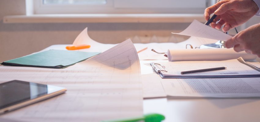 Architect alone at his working place. Paperwork